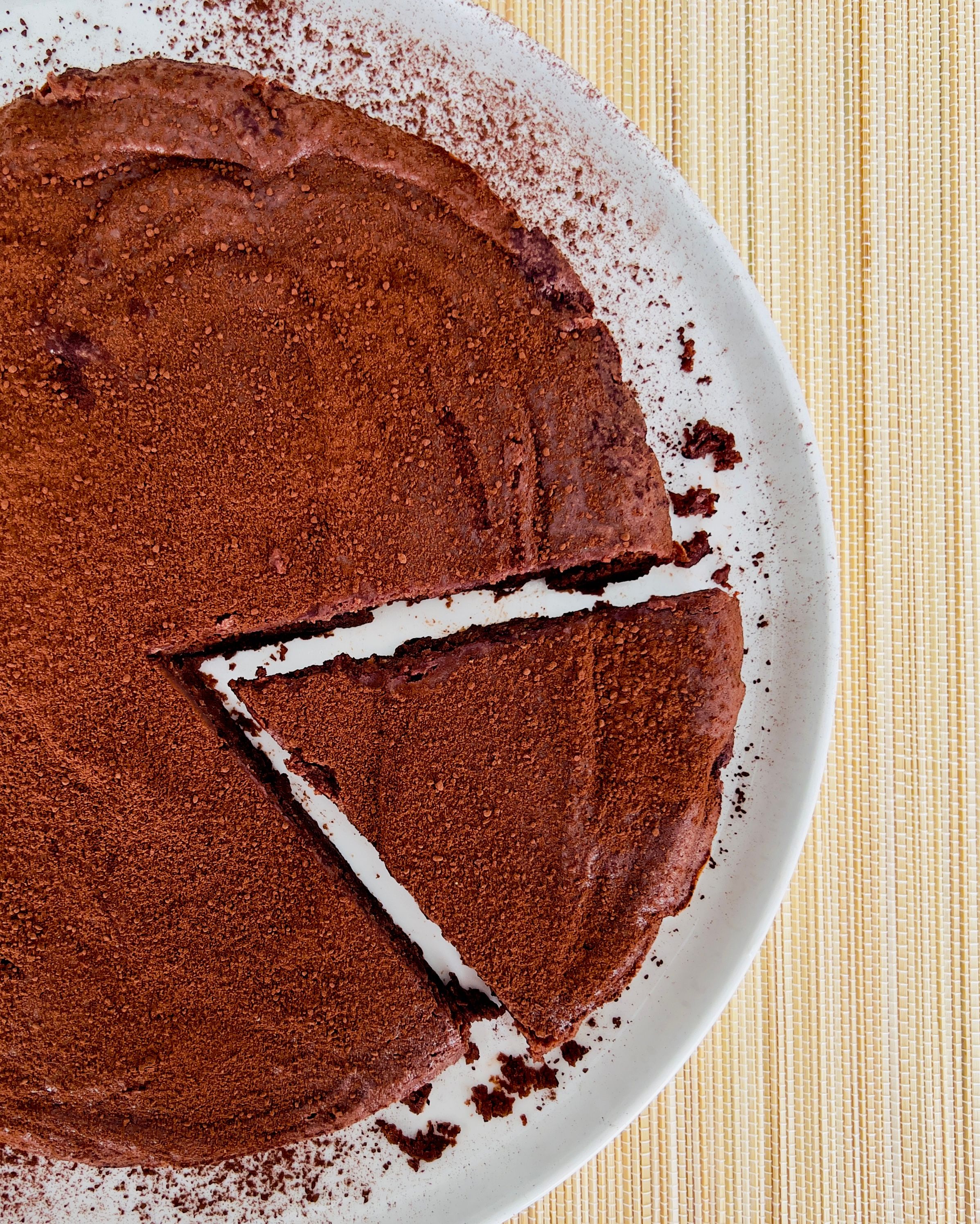A slice of rich chocolate and ricotta cake, showcasing its moist texture and dark color.