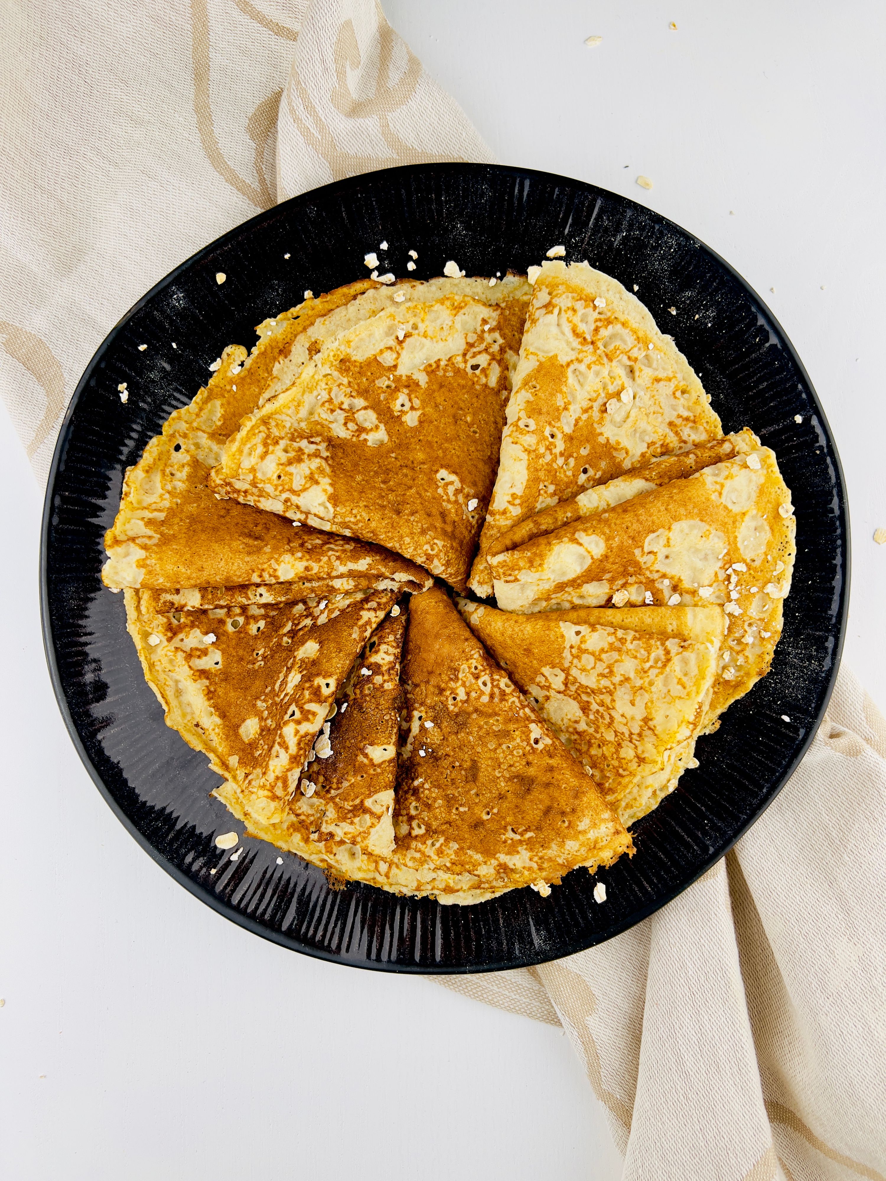 Close-up of a portion of crumble, with a golden, textured topping and soft apple filling, served on a plate with a vintage spoon.